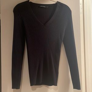 Black ribbed V-neck sweater with button details at wrist